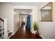 Bright hallway with hardwood floors and view to dining room at 128 Bruce Dr, Cary, NC 27511