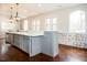 Modern kitchen with large island and white quartz countertops at 128 Bruce Dr, Cary, NC 27511