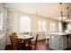 Bright kitchen features an island, white cabinets, and a charming eat-in area at 128 Bruce Dr, Cary, NC 27511