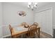 Bright dining area with wood table and chairs, and a view to kitchen at 130 Twin Oaks Dr, Durham, NC 27712