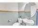 Stylish powder room features a pedestal sink and a large oval mirror at 148 Aylebury Rdg, Zebulon, NC 27597