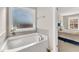 Relaxing bathroom with a bathtub and adjacent bedroom view at 148 Aylebury Rdg, Zebulon, NC 27597