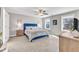 Bright bedroom with a blue upholstered bed and two windows offering natural light at 148 Aylebury Rdg, Zebulon, NC 27597