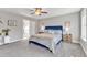 Spacious bedroom with plush carpet, a comfortable bed, and lots of natural light at 148 Aylebury Rdg, Zebulon, NC 27597