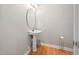 Small bathroom with pedestal sink, mirror, and wood floor at 2108 White Pond Ct, Apex, NC 27523