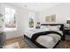 Bright bedroom with hardwood floors, large windows, and king-size bed at 214 W Maynard Ave, Durham, NC 27704