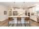 Kitchen island with seating and white cabinetry at 2371 Kettle Falls Sta, Apex, NC 27502