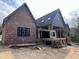 Brick exterior with a partially covered porch and multiple large windows at 274 Westhampton Dr, Pittsboro, NC 27312