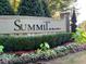 Daytime view of the Summit by Sage Built community entrance sign surrounded by lush landscaping at 274 Westhampton Dr, Pittsboro, NC 27312