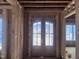 Entryway under construction showcases a decorative front door with wood framing and ample natural light at 274 Westhampton Dr, Pittsboro, NC 27312