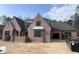 Beautiful brick home with craftsman details, gray roof and black trimmed windows at 274 Westhampton Dr, Pittsboro, NC 27312