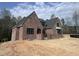 Expansive brick home with large windows and a partially visible three-car garage at 274 Westhampton Dr, Pittsboro, NC 27312