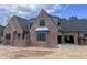 Brick exterior showcasing classic design elements and large windows at 274 Westhampton Dr, Pittsboro, NC 27312