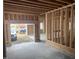 Garage under construction featuring concrete flooring, ample space, and exposed wood framing at 274 Westhampton Dr, Pittsboro, NC 27312