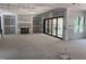 Unfinished interior space with a stone fireplace, drywall, sliding glass doors, and large window views at 274 Westhampton Dr, Pittsboro, NC 27312