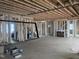 A spacious living room under construction featuring exposed wood framing and a cozy fireplace at 274 Westhampton Dr, Pittsboro, NC 27312
