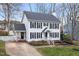 Two-story white house with black shutters, landscaping, and a driveway at 2817 Hiking Trl, Raleigh, NC 27615