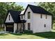 Modern farmhouse style home with white siding and a dark roof at 2961 Forest Creek Ln, Mebane, NC 27302