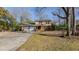 Two-story brick house with attached garage and mature trees surrounding the property at 3042 Marlborough Rd, Burlington, NC 27215