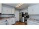 Updated kitchen with stainless steel appliances and white cabinets at 3042 Marlborough Rd, Burlington, NC 27215
