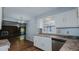 Kitchen with view into living room, featuring a brick fireplace at 3042 Marlborough Rd, Burlington, NC 27215
