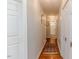 Bright hallway with hardwood floors and access to bedrooms and bathroom at 313 Cayman Ave, Holly Springs, NC 27540