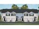 Three-unit townhome building with attached garages and landscaping at 315 Cherry Laurel Dr, Sanford, NC 27332