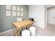 Light-filled home office features a wood desk, two ottomans, and framed botanical prints at 319 Cherry Laurel Dr, Sanford, NC 27332