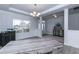 Bright dining room with hardwood floors, chandelier, and view to entryway at 33 Sunburst Ct, Fuquay Varina, NC 27526