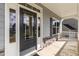Modern front door with sidelights and a covered porch at 33 Sunburst Ct, Fuquay Varina, NC 27526