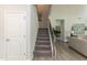 Staircase with carpet runner, metal railing, and views of living area and bedroom at 33 Sunburst Ct, Fuquay Varina, NC 27526