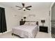 Cozy bedroom with dresser, striped bedding, and ceiling fan at 36 Mountain View Dr, Garner, NC 27529