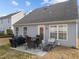 Backyard patio with table, chairs, and grill at 3838 Potecasi Dr, Raleigh, NC 27610