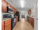 Kitchen with granite countertops, dark wood cabinets, and black appliances at 3838 Potecasi Dr, Raleigh, NC 27610