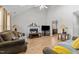 Living room with hardwood floors, fireplace, and view into kitchen area at 3838 Potecasi Dr, Raleigh, NC 27610