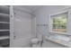 Bathroom with shower, built-in shelves, and granite vanity at 411 E Green St, Franklinton, NC 27525