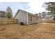The backyard features a new fence and gray siding, with a concrete pad, air conditioning unit, and well-maintained surroundings at 420 E Cedar Ave, Wake Forest, NC 27587