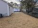 View of the spacious backyard, featuring newly laid straw and ready for landscaping at 420 E Cedar Ave, Wake Forest, NC 27587