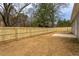 Large backyard featuring a newly installed wooden fence and concrete patio area, perfect for outdoor activities and privacy at 420 E Cedar Ave, Wake Forest, NC 27587