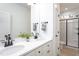 Elegant bathroom with dual sinks, quartz countertops, matte black fixtures, and sleek glass shower at 420 E Cedar Ave, Wake Forest, NC 27587