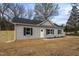 Well-maintained home featuring gray siding, black shutters, a dark roof, and new landscaping, showcasing modern upgrades at 420 E Cedar Ave, Wake Forest, NC 27587