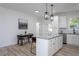 Modern kitchen showcasing a large island with granite countertops and stainless steel appliances at 420 E Cedar Ave, Wake Forest, NC 27587