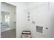 Practical laundry room with washer/dryer hookups and convenient overhead shelving at 420 E Cedar Ave, Wake Forest, NC 27587