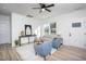 Open-concept living room featuring neutral decor, wood-look floors, and access to the entryway and other rooms at 420 E Cedar Ave, Wake Forest, NC 27587