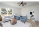 Inviting living room with modern furnishings, light-colored walls, and vinyl flooring with an entry bench near door at 420 E Cedar Ave, Wake Forest, NC 27587