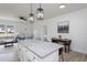 Open concept living space with kitchen island, dining table, and living area, ideal for modern living at 420 E Cedar Ave, Wake Forest, NC 27587