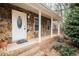 Inviting front entrance with stone facade and covered porch at 4304 Maggie Ct, Liberty, NC 27298