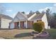 Brick ranch house with landscaping and propane tank at 4314 Chimney Stone Rd, Durham, NC 27704