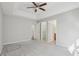 Main bedroom with ceiling fan, neutral walls, and access to bathroom and closet at 4314 Chimney Stone Rd, Durham, NC 27704