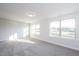 Bright bedroom with gray carpeting and two large windows at 45 River Chapel Dr, Fuquay Varina, NC 27526